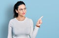 Young hispanic woman pointing with fingers to the side smiling looking to the side and staring away thinking Royalty Free Stock Photo