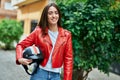 Young hispanic woman smiling happy holding moto helmet at the city Royalty Free Stock Photo