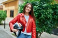 Young hispanic woman smiling happy holding moto helmet at the city Royalty Free Stock Photo