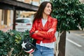 Young hispanic woman smiling happy holding moto helmet at the city Royalty Free Stock Photo