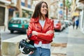 Young hispanic woman smiling happy holding moto helmet at the city Royalty Free Stock Photo