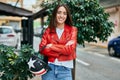 Young hispanic woman smiling happy holding moto helmet at the city Royalty Free Stock Photo