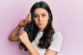 Young hispanic woman styling hair using comb depressed and worry for distress, crying angry and afraid Royalty Free Stock Photo