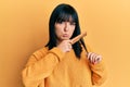 Young hispanic woman styling hair using comb depressed and worry for distress, crying angry and afraid Royalty Free Stock Photo