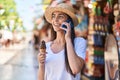 Young hispanic woman tourist talking on the smartphone eating ice cream at street market Royalty Free Stock Photo