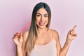 Young hispanic woman using file nail smiling happy pointing with hand and finger to the side Royalty Free Stock Photo