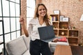 Young hispanic woman using laptop showing blank screen at home smiling happy pointing with hand and finger to the side Royalty Free Stock Photo