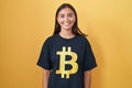 Young hispanic woman wearing bitcoin t shirt with a happy and cool smile on face