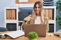 Young hispanic woman wearing call center agent headset working at the office pointing finger to one self smiling happy and proud Royalty Free Stock Photo