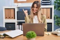 Young hispanic woman wearing call center agent headset working at the office smiling happy pointing with hand and finger to the Royalty Free Stock Photo