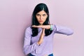 Young hispanic woman wearing casual clothes doing time out gesture with hands, frustrated and serious face Royalty Free Stock Photo