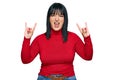 Young hispanic woman wearing casual clothes shouting with crazy expression doing rock symbol with hands up Royalty Free Stock Photo
