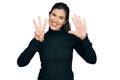 Young hispanic woman wearing casual clothes showing and pointing up with fingers number eight while smiling confident and happy Royalty Free Stock Photo