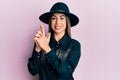 Young hispanic woman wearing cowgirl style doing pistol gesture with hands smiling with a happy and cool smile on face Royalty Free Stock Photo