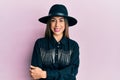 Young hispanic woman wearing cowgirl style happy face smiling with crossed arms looking at the camera Royalty Free Stock Photo