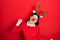 Young hispanic woman wearing deer christmas hat and red nose dancing happy and cheerful, smiling moving casual and confident Royalty Free Stock Photo