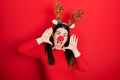Young hispanic woman wearing deer christmas hat and red nose smiling cheerful playing peek a boo with hands showing face Royalty Free Stock Photo