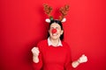 Young hispanic woman wearing deer christmas hat and red nose very happy and excited doing winner gesture with arms raised, smiling Royalty Free Stock Photo