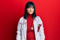 Young hispanic woman wearing doctor uniform and stethoscope looking sleepy and tired, exhausted for fatigue and hangover, lazy Royalty Free Stock Photo