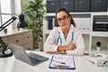 Young hispanic woman wearing doctor uniform and stethoscope looking sleepy and tired, exhausted for fatigue and hangover, lazy Royalty Free Stock Photo