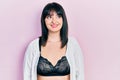 Young hispanic woman wearing lingerie looking away to side with smile on face, natural expression Royalty Free Stock Photo
