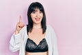 Young hispanic woman wearing lingerie pointing finger up with successful idea Royalty Free Stock Photo