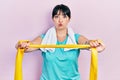 Young hispanic woman wearing sportswear and arm band puffing cheeks with funny face Royalty Free Stock Photo