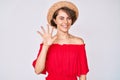 Young hispanic woman wearing summer hat showing and pointing up with fingers number five while smiling confident and happy Royalty Free Stock Photo