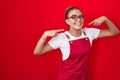 Young hispanic woman wearing waitress apron over red background smiling cheerful showing and pointing with fingers teeth and mouth