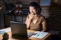 Young hispanic woman working at the office at night bored yawning tired covering mouth with hand Royalty Free Stock Photo