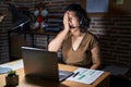 Young hispanic woman working at the office at night yawning tired covering half face, eye and mouth with hand Royalty Free Stock Photo