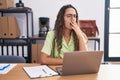 Young hispanic woman working at the office wearing glasses bored yawning tired covering mouth with hand Royalty Free Stock Photo