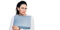 Young hispanic woman working using computer laptop clueless and confused expression Royalty Free Stock Photo