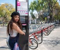 Young hispter lady using the street bikes of the mexican urban program EcoBici