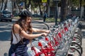 Young hispter lady using the street bikes of the mexican urban program EcoBici