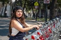 Young hispter lady using the street bikes of the mexican urban program EcoBici