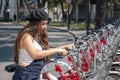 Young hispter lady using the street bikes of the mexican urban program EcoBici