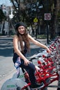 Young hispter lady using the street bikes of the mexican urban program EcoBici