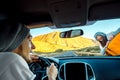 Young hitchhiker on the road and man driving Royalty Free Stock Photo