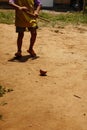 young Hmong boy playing with his homemade timber spinning top