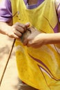 young Hmong boy playing with his homemade timber spinning top