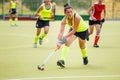 Young hockey player woman with ball in attack