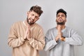 Young homosexual couple standing over white background begging and praying with hands together with hope expression on face very Royalty Free Stock Photo