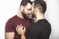 Young homosexuals gay couple love each other on a white background.