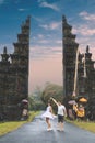 Young honeymoon couple on a big balinese gates background. Bali island, Indonesia.