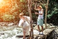 Young honeymoon newleds couple on a mountain river. Bali island.