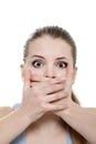 Young horrified woman closing her mouth with hands Royalty Free Stock Photo
