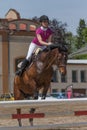 Young horsewoman in action. Vertically.