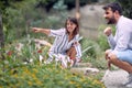 Young  horticulturists woman and man at  beautiful flower garden  working together Royalty Free Stock Photo