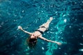 Young hot woman resting alone. Picture of calm relaxed girl in water swimming. Looking up in sky and taking sunbathing Royalty Free Stock Photo